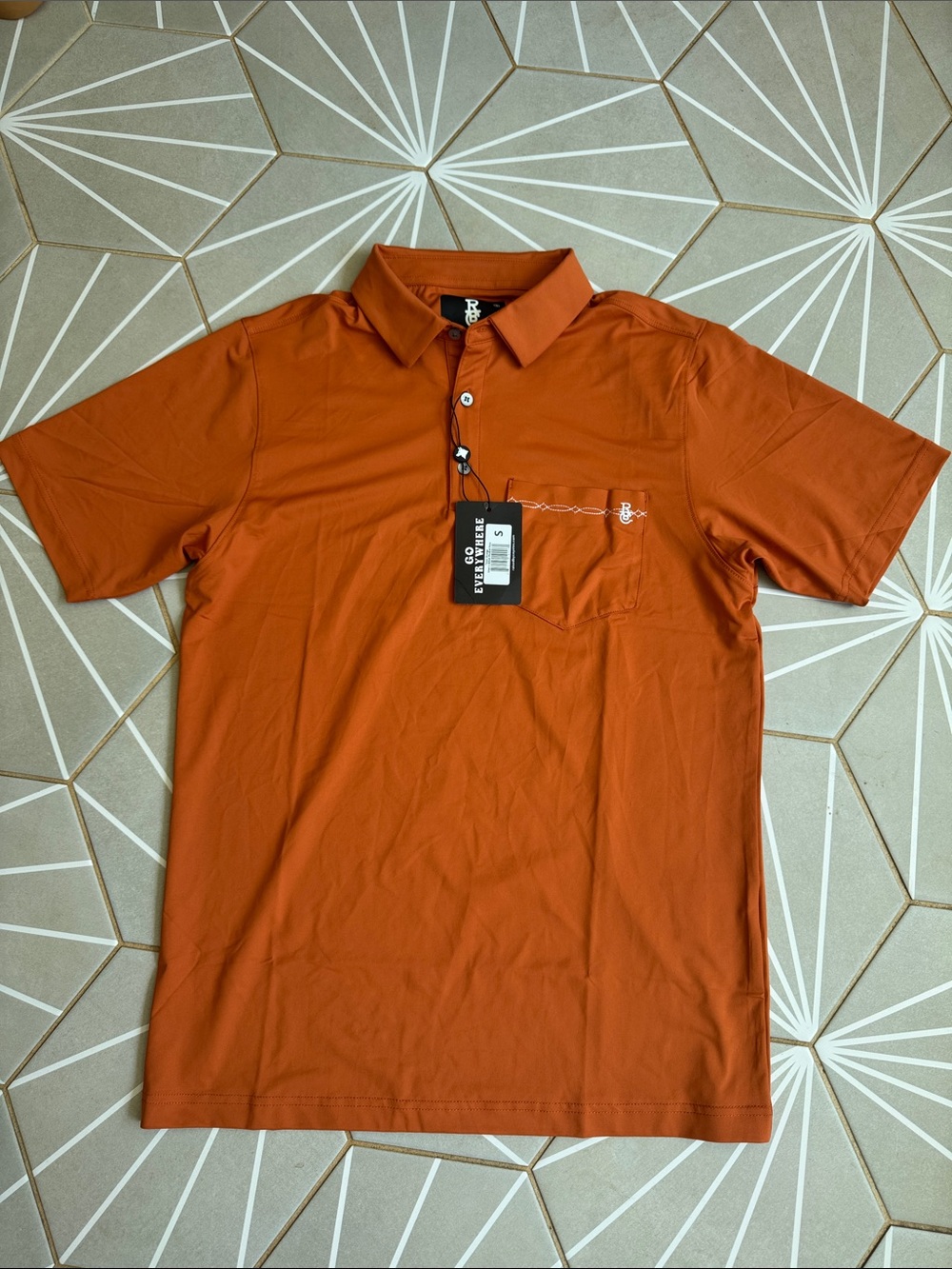 Raised by Coyotes Men's Short-Sleeve Polo in Burnt Orange with Chest Pocket
